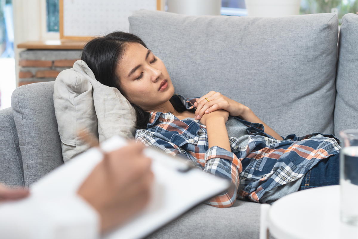 woman lying on sofa